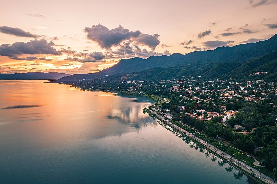 An aerial view of Ajijic at sunset, the town along the malecón with Lake Chapala and the mountains